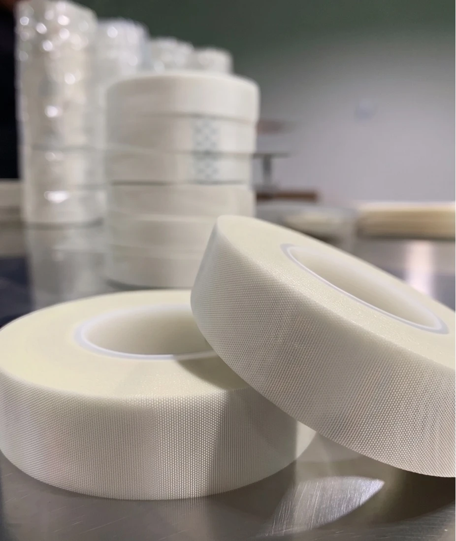 Finished white glass cloth tape rolls on plastic cores